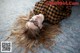 A woman laying on the floor with her hair blowing in the wind.