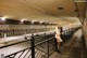 A naked woman standing in a subway station.