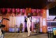 A naked woman wearing a face mask standing in front of a restaurant.