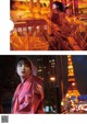 A woman standing in front of the Eiffel Tower at night.