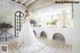 A woman in a wedding dress standing in a room.