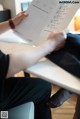 A person sitting at a table reading a book.