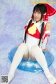 A woman in a white and red outfit sitting on an inflatable ring.